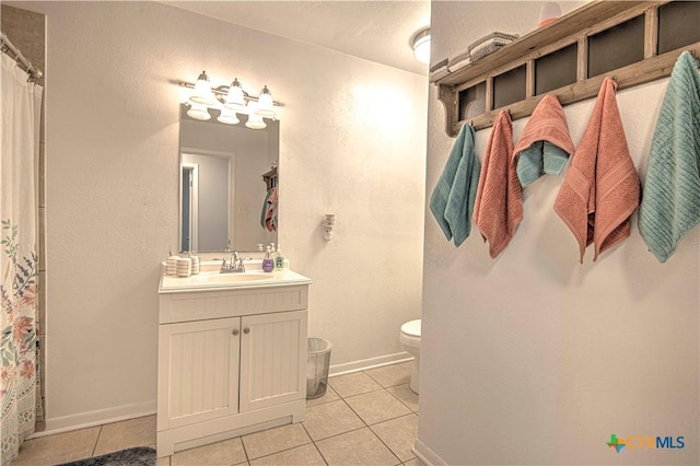 bathroom with tile patterned floors, toilet, and vanity