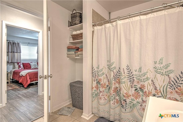 bathroom featuring hardwood / wood-style flooring and walk in shower