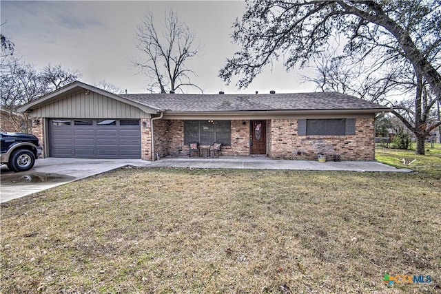 ranch-style home featuring a garage and a front lawn