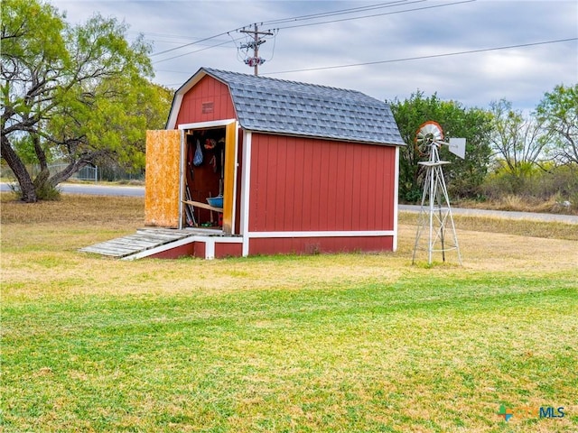 view of outbuilding with a yard