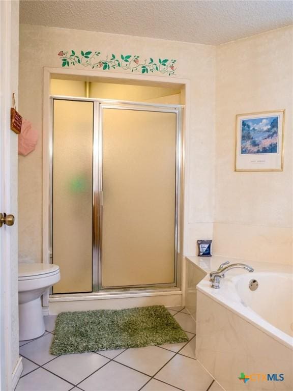 bathroom with toilet, tile patterned floors, a textured ceiling, and separate shower and tub