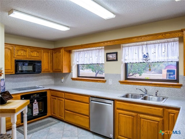 kitchen featuring black appliances, backsplash, sink, and a textured ceiling