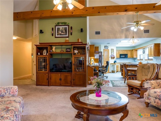 living room with ceiling fan, beamed ceiling, high vaulted ceiling, and light colored carpet