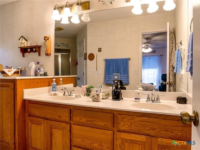 bathroom featuring vanity, an enclosed shower, and ceiling fan with notable chandelier