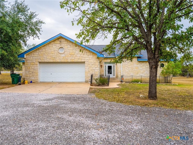 ranch-style home featuring a garage