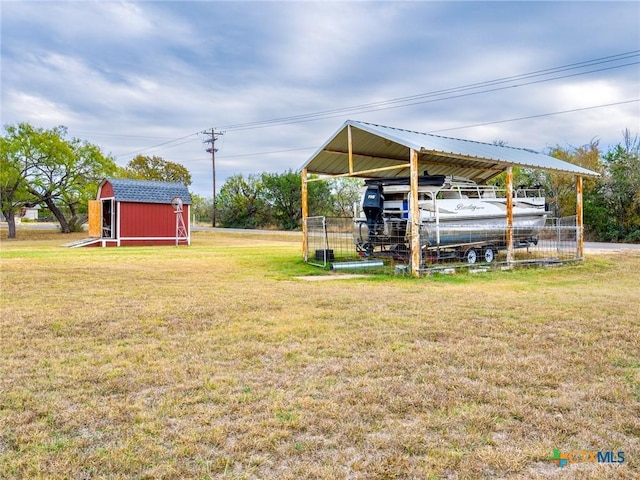 view of yard with a shed and a carport