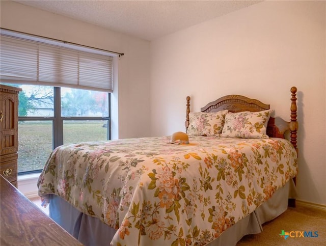 carpeted bedroom featuring a textured ceiling