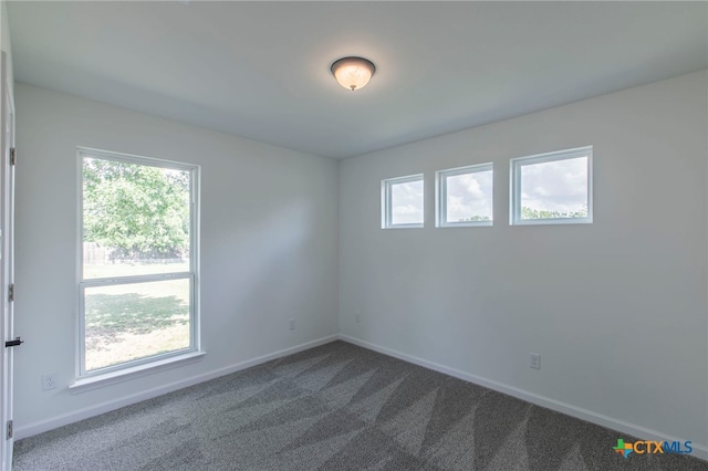 575 Live Oak Dr, Bertram, TX 78605 - unfurnished room with dark colored carpet and baseboards