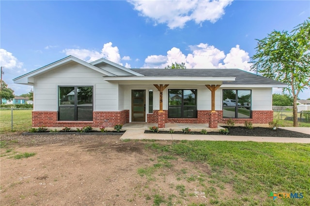 575 Live Oak Dr, Bertram, TX 78605 - view of front of property featuring brick siding, covered porch, and a shingled roof