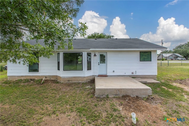 575 Live Oak Dr, Bertram, TX 78605 - back of house featuring a yard, a patio area, and a shingled roof