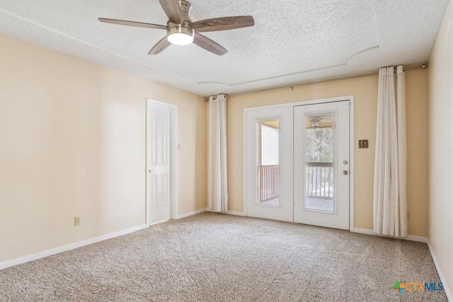 carpeted empty room featuring a textured ceiling, baseboards, and ceiling fan