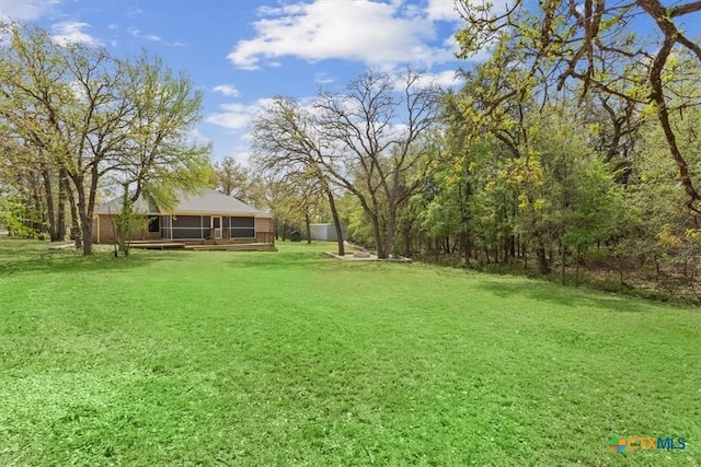 view of yard with a sunroom