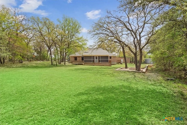 view of yard with a sunroom