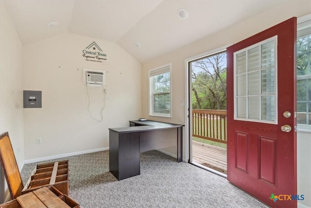 carpeted home office with baseboards, vaulted ceiling, and a wall unit AC