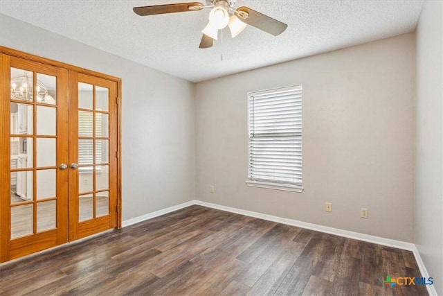 spare room with dark wood-style floors, baseboards, and french doors