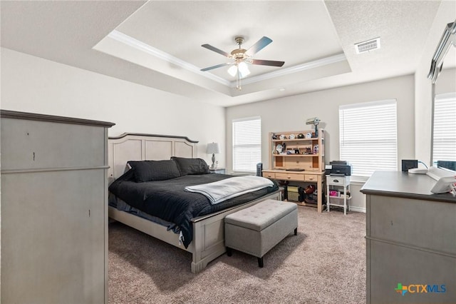 2635 Bolzano Trl, Temple, TX 76502 - bedroom featuring a raised ceiling, crown molding, multiple windows, light colored carpet, and a ceiling fan