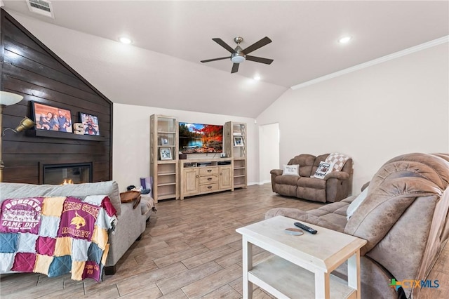 2635 Bolzano Trl, Temple, TX 76502 - living area featuring lofted ceiling, ceiling fan, light wood-type flooring, a large fireplace, and ornamental molding