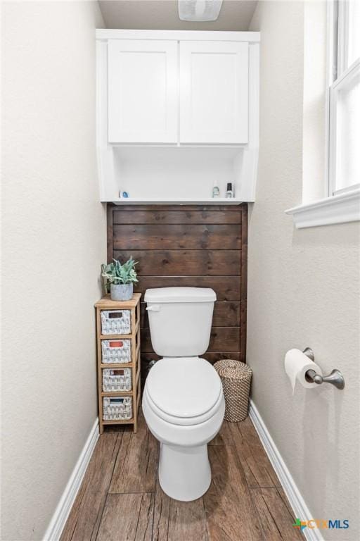 2635 Bolzano Trl, Temple, TX 76502 - bathroom featuring wood finished floors, baseboards, and toilet