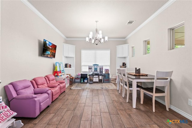 2635 Bolzano Trl, Temple, TX 76502 - living room featuring a chandelier, ornamental molding, wood finished floors, and baseboards