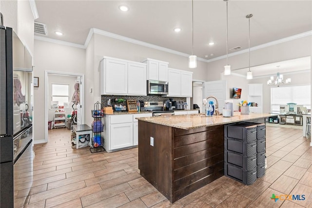 2635 Bolzano Trl, Temple, TX 76502 - kitchen with appliances with stainless steel finishes, a sink, backsplash, white cabinets, and crown molding