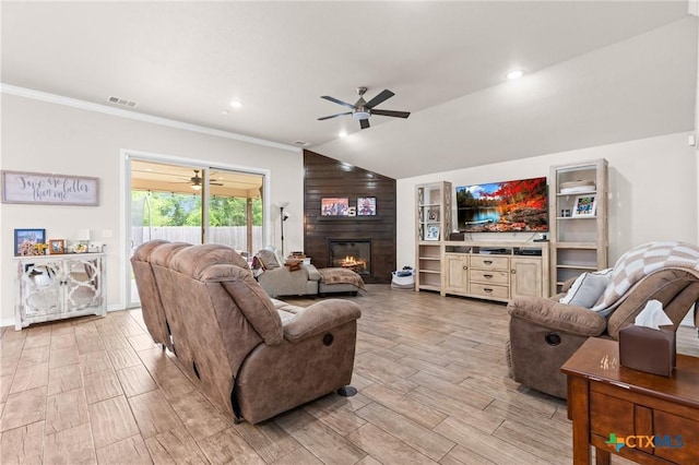 2635 Bolzano Trl, Temple, TX 76502 - living area with a ceiling fan, a fireplace, light wood-type flooring, vaulted ceiling, and crown molding