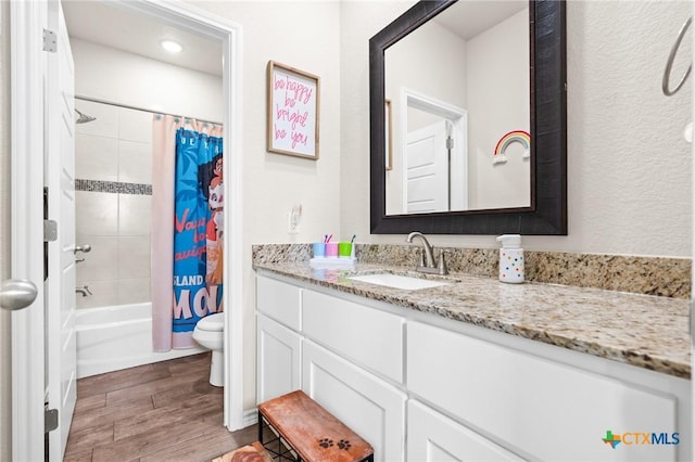 2635 Bolzano Trl, Temple, TX 76502 - bathroom with toilet, wood finished floors, vanity, and shower / tub combo