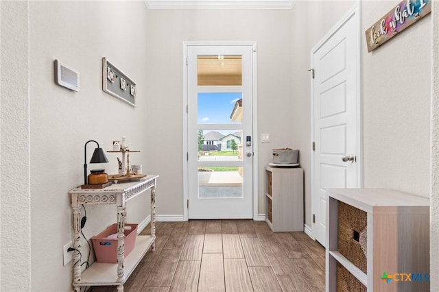 2635 Bolzano Trl, Temple, TX 76502 - foyer with wood finished floors, crown molding, and baseboards