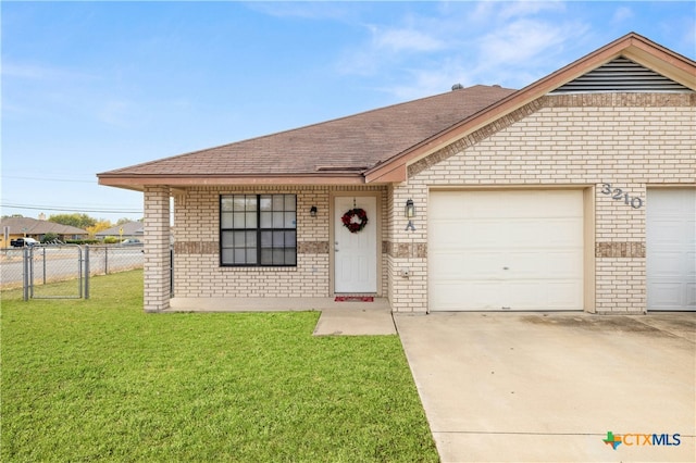 view of front of property featuring a garage and a front lawn