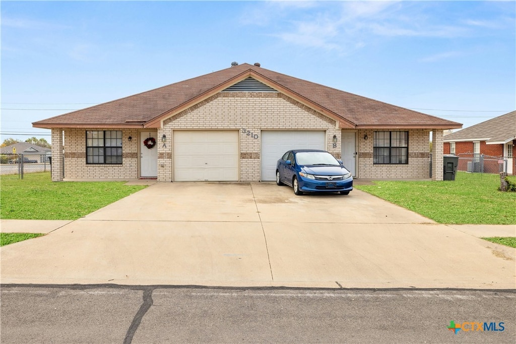 ranch-style home featuring a front yard and a garage