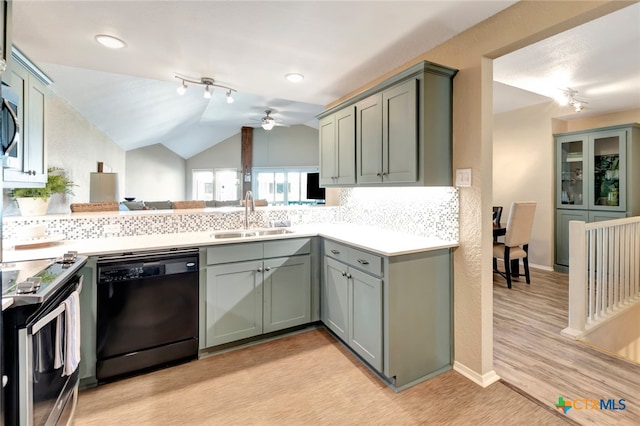 kitchen with stainless steel appliances, ceiling fan, sink, light hardwood / wood-style floors, and lofted ceiling