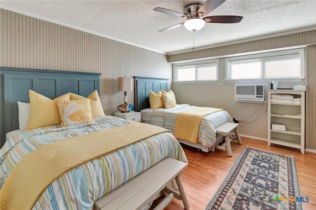 bedroom featuring hardwood / wood-style flooring, multiple windows, and ceiling fan