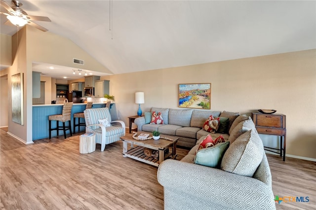 living room featuring ceiling fan, high vaulted ceiling, and light hardwood / wood-style floors