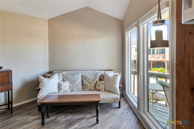 sitting room with hardwood / wood-style floors and lofted ceiling