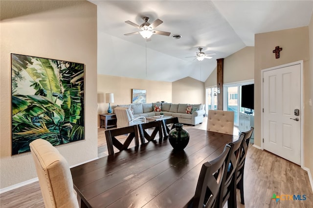 dining room featuring wood-type flooring, ceiling fan, and lofted ceiling