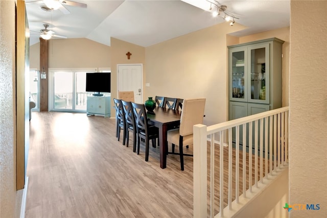 dining room featuring ceiling fan, light hardwood / wood-style floors, and vaulted ceiling