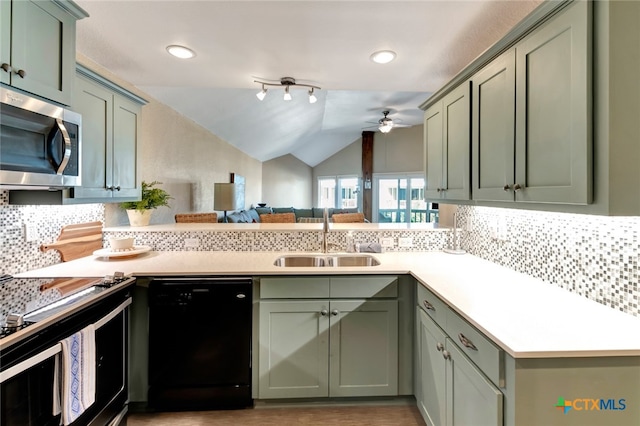 kitchen with ceiling fan, sink, black dishwasher, backsplash, and vaulted ceiling