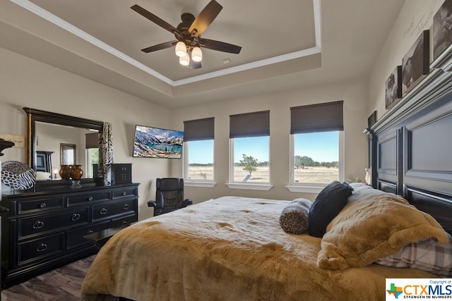 bedroom with ceiling fan, crown molding, and a tray ceiling