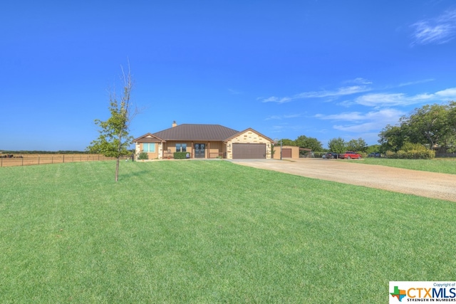 ranch-style home featuring a garage and a front lawn