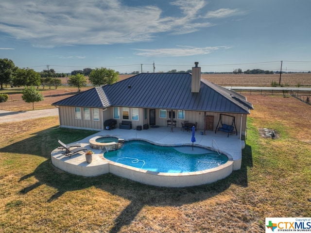 view of swimming pool with a lawn, an in ground hot tub, and a patio area