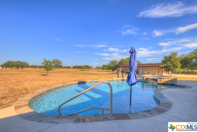 view of pool featuring an in ground hot tub