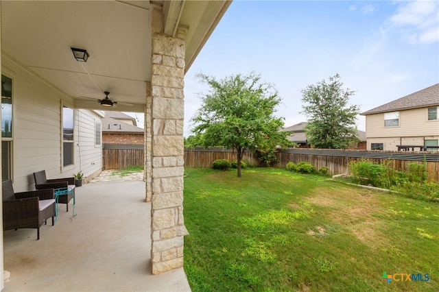 view of yard featuring a patio area and ceiling fan