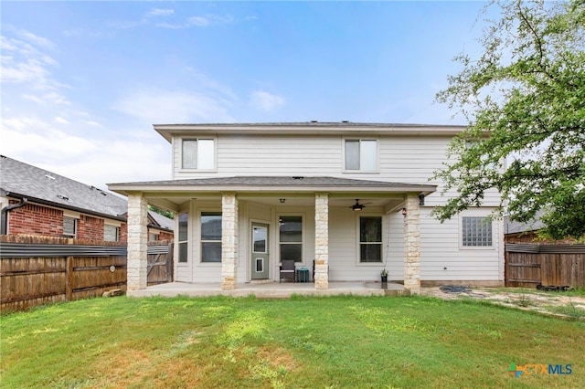 back of property with a patio, a lawn, and ceiling fan