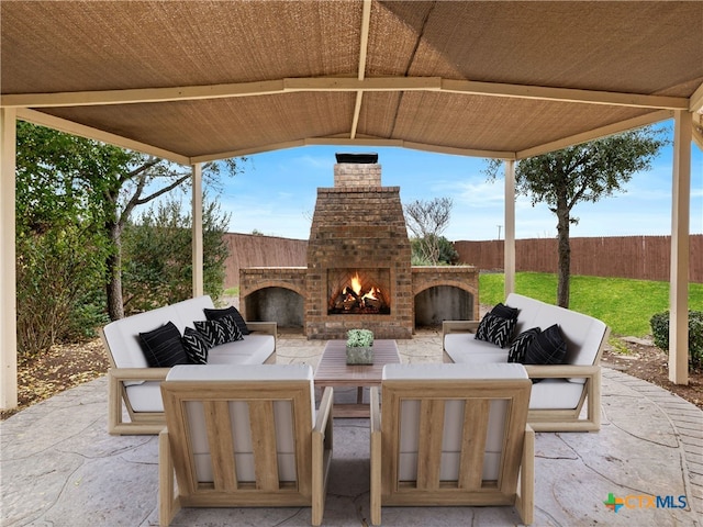 view of patio / terrace with an outdoor living space with a fireplace