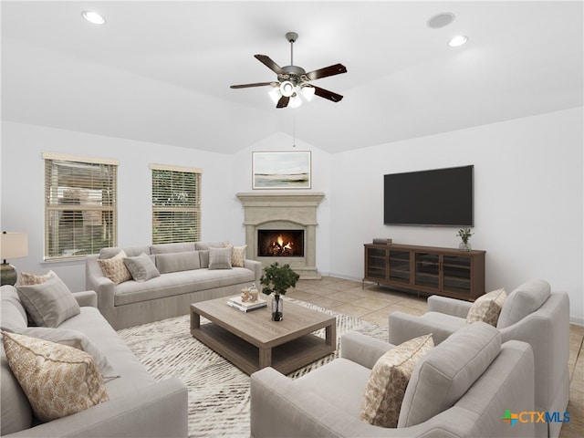 living room featuring light tile patterned floors, vaulted ceiling, and ceiling fan