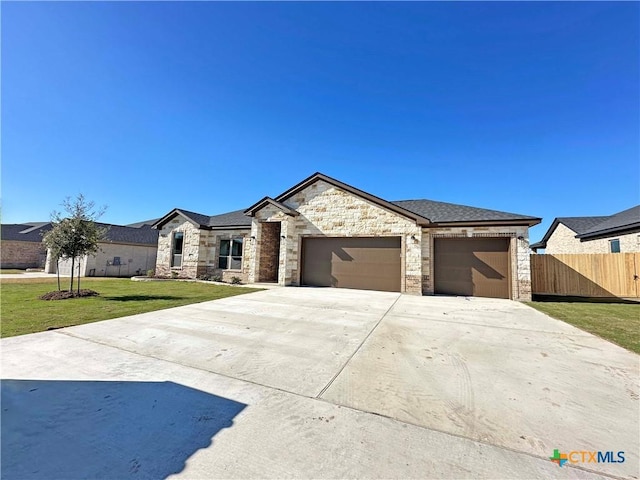 view of front of home featuring a garage and a front yard