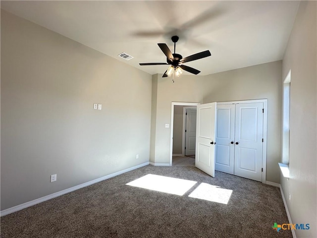 unfurnished bedroom featuring ceiling fan, carpet floors, and a closet