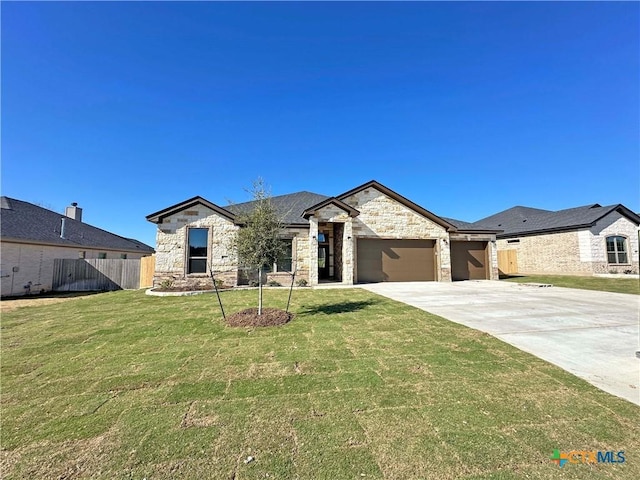 view of front of home with a front yard and a garage