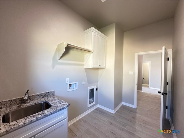 laundry room featuring sink, washer hookup, cabinets, hookup for an electric dryer, and light wood-type flooring