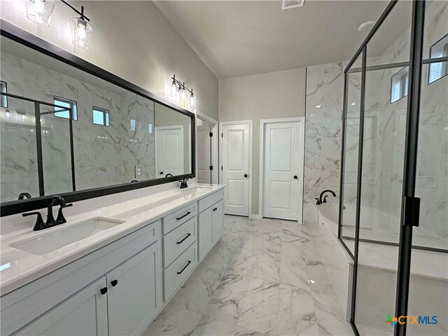 bathroom with vanity and shower with separate bathtub