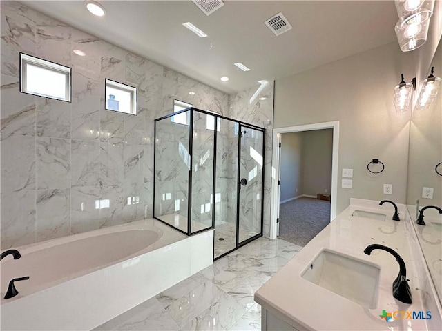 bathroom featuring vanity and independent shower and bath